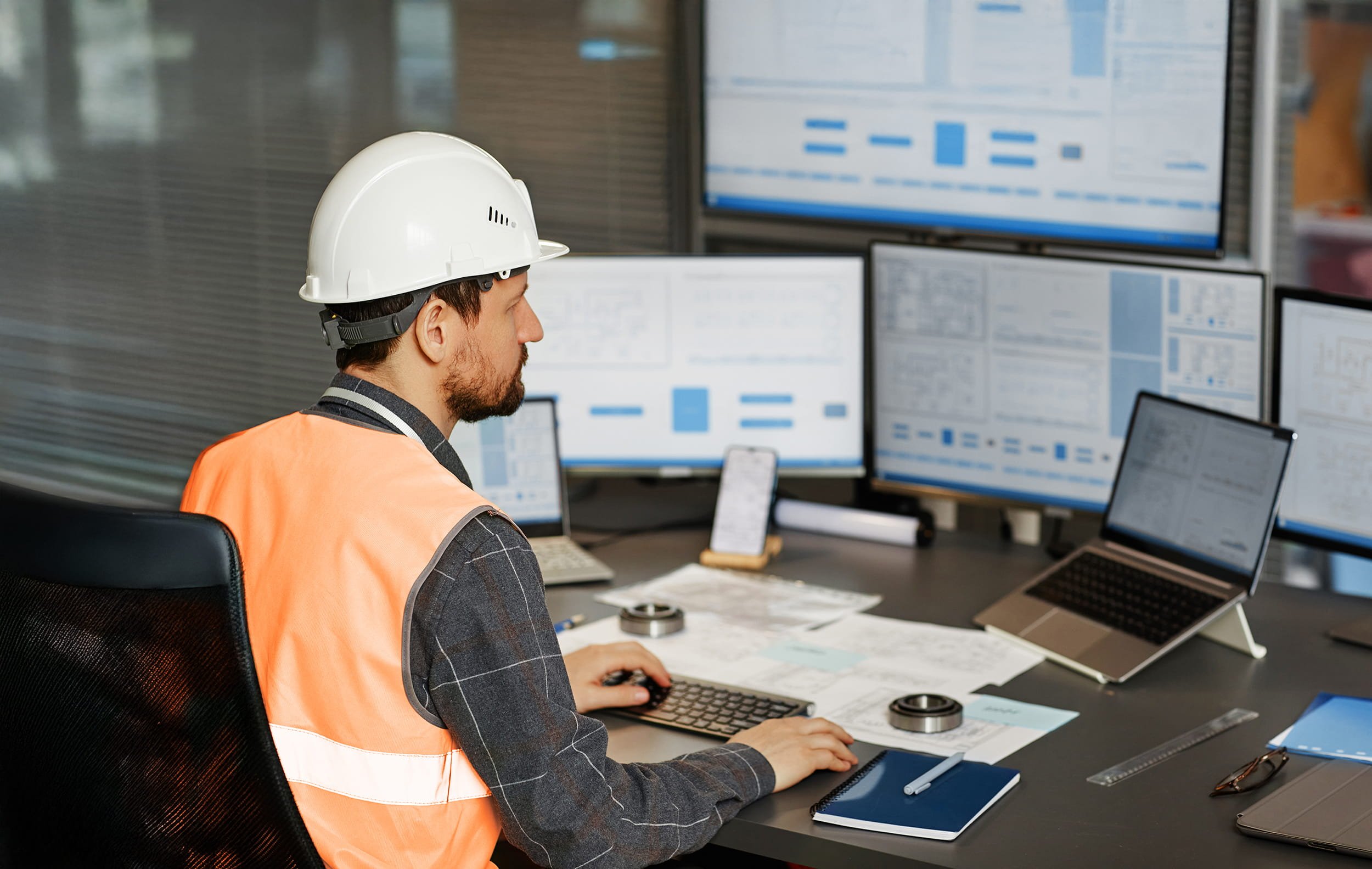 Civil engineer reviewing project data on laptop