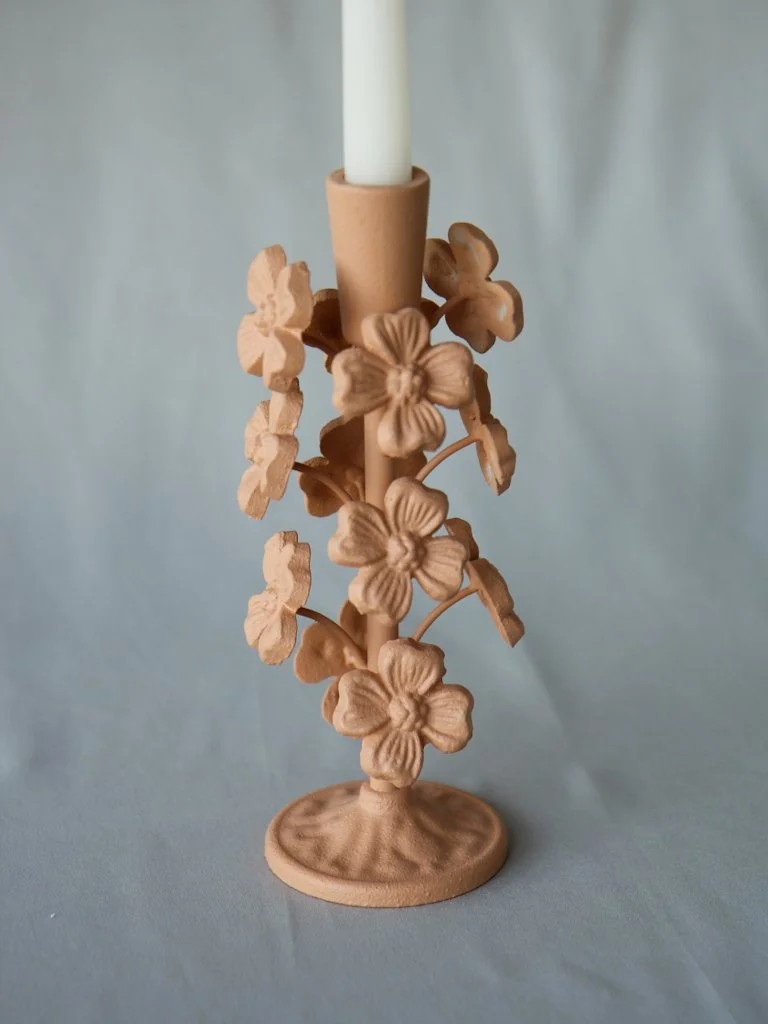 Decorative candle holder with clay flower design around the central candle