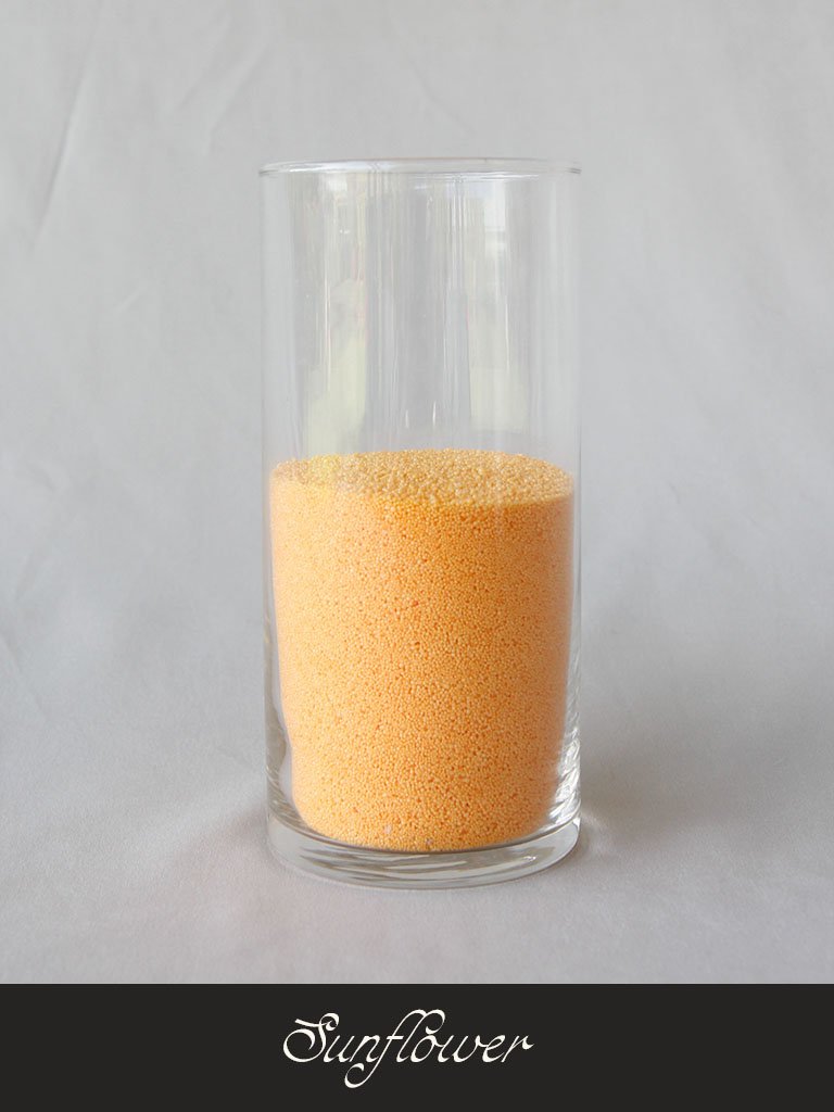 A clear glass filled with yellow-orange granules, labeled 'Sunflower' at the bottom.