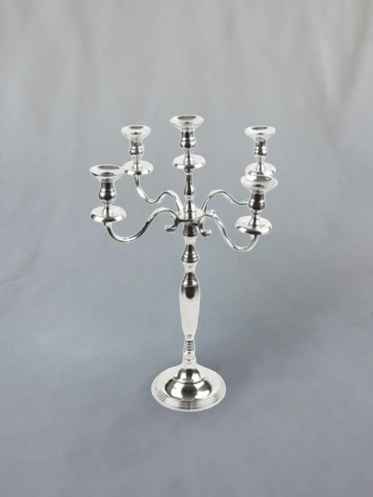 Silver candelabrum with five candle holders on a plain surface.