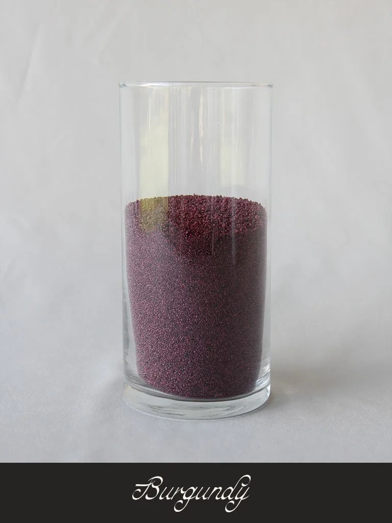A tall clear glass filled with tiny burgundy-colored granules labeled 'Burgundy' at the bottom.