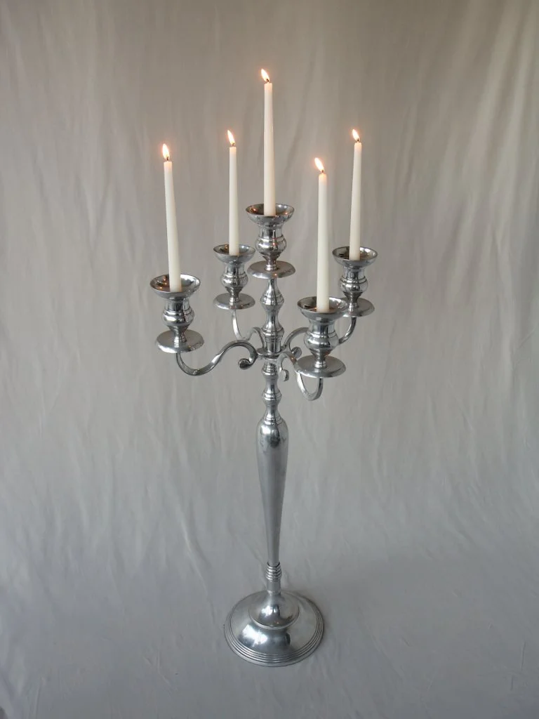 Silver candelabra with six lit white candles