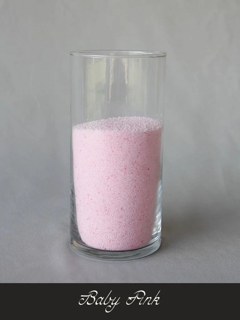 A tall clear glass filled with pink powdered substance labeled 'Baby Pink'.