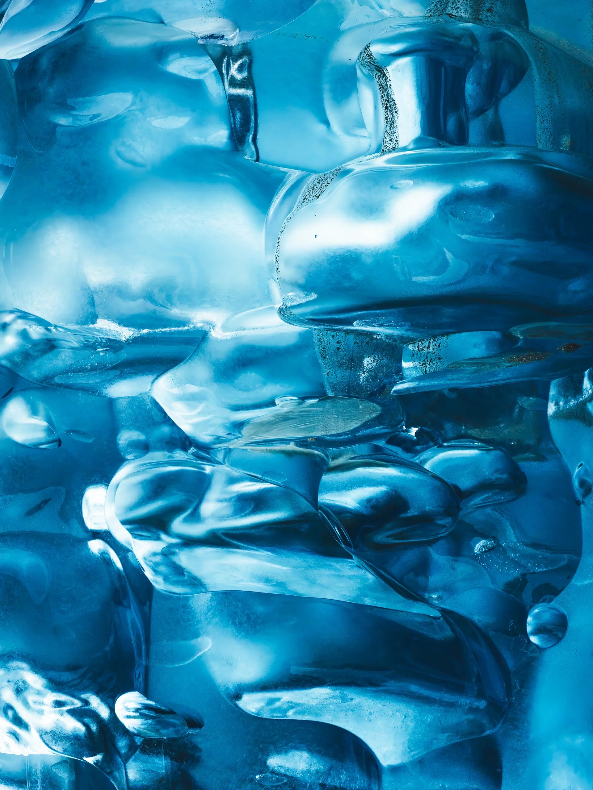Close-up of a glacier ice block with smooth, shiny surfaces.