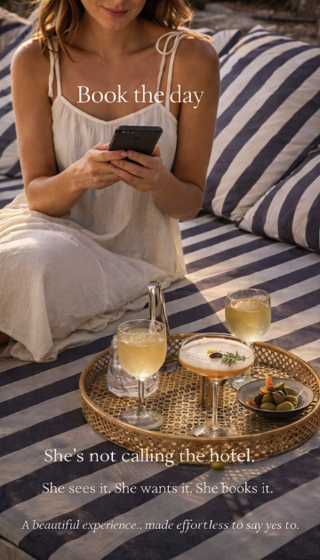 Woman sitting on bed with striped bedding, holding a phone, with a tray of drinks and snacks nearby. The text reads: 'Book the day. She's not calling the hotel. She sees it. She wants it. She books it. A beautiful experience... made effortless to say yes to.'