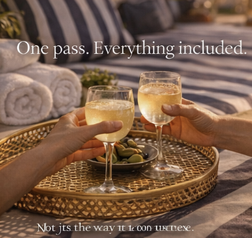 Two hands holding glasses of white wine for a toast on a round woven tray, with towels and a bed in the background, and text that says, 'One pass. Everything included. Not just the way it is on vacation.'