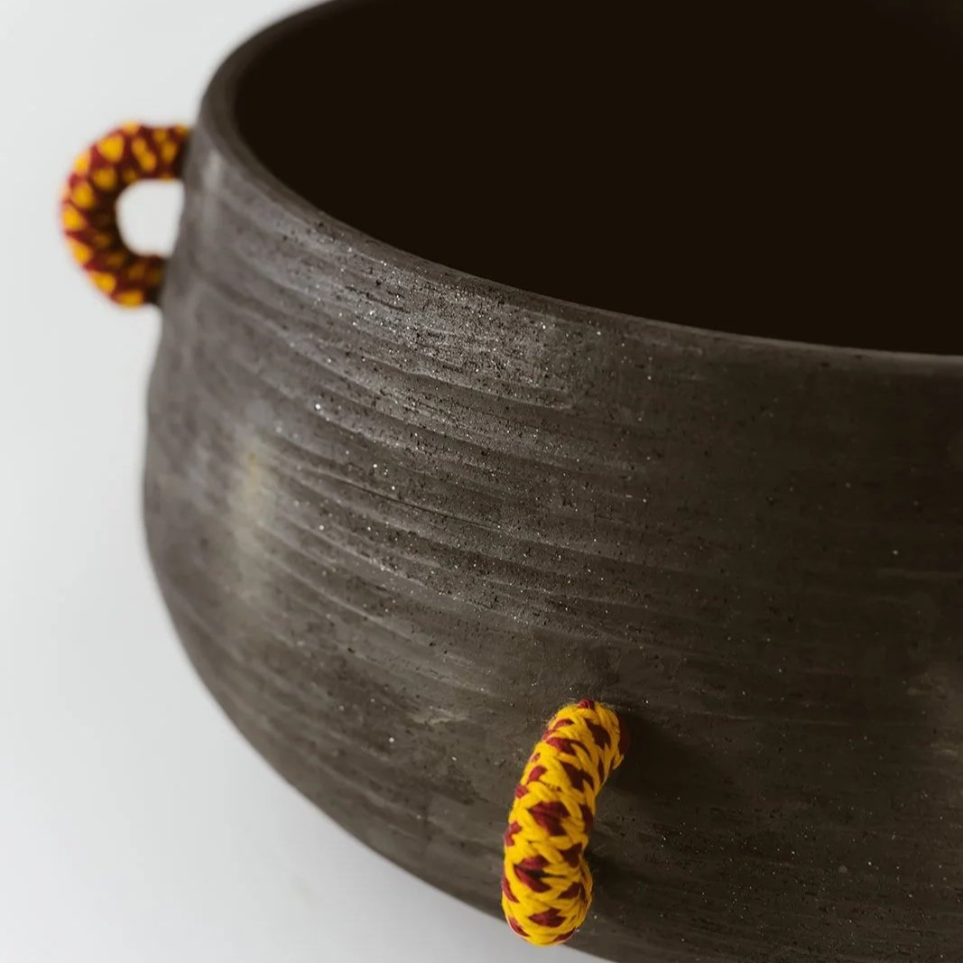 Echo handmade black pottery decorative bowl featuring intricate hand-woven fiber detailing and organic texture