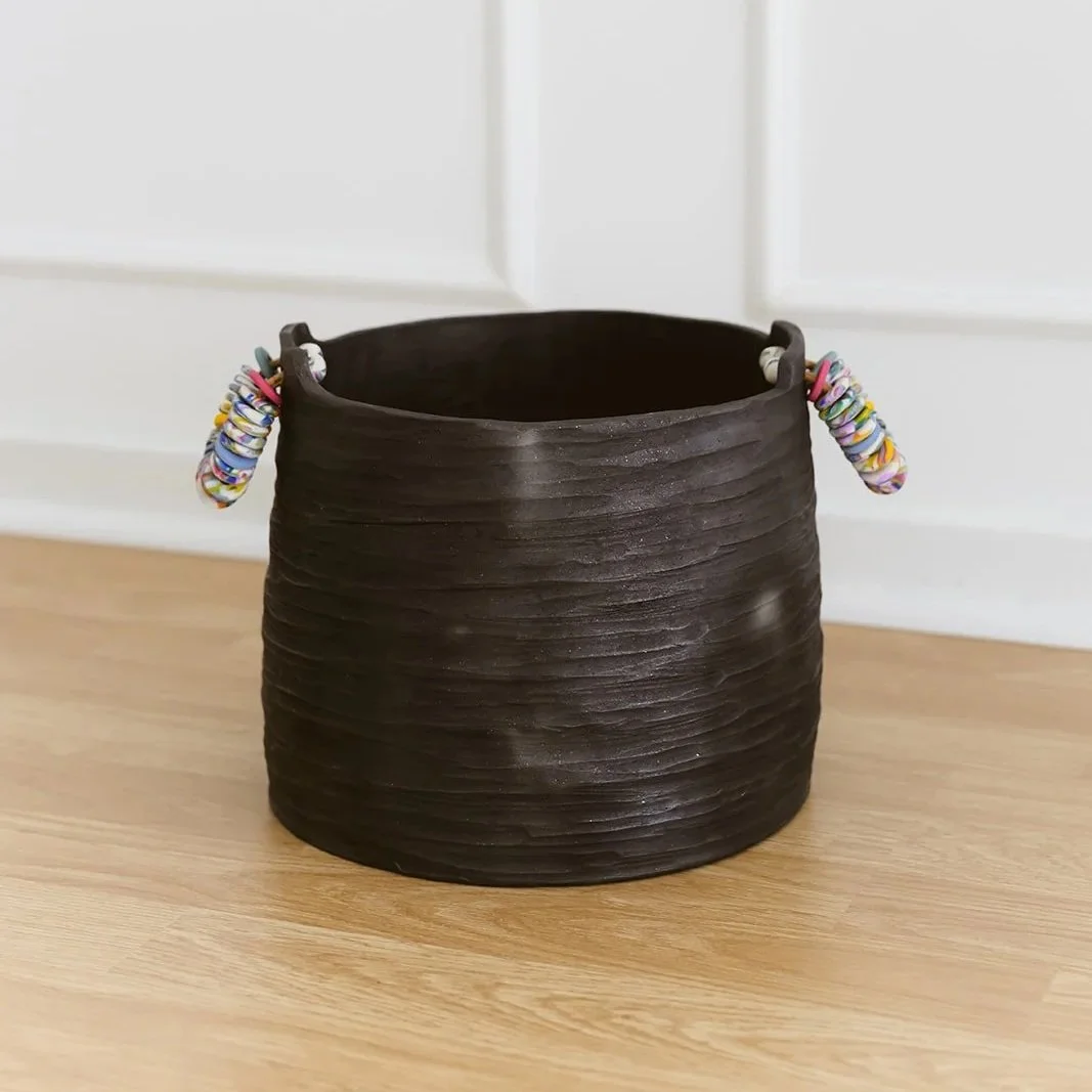 Noir handmade black pottery vase with textured finish and vibrant colorful rings