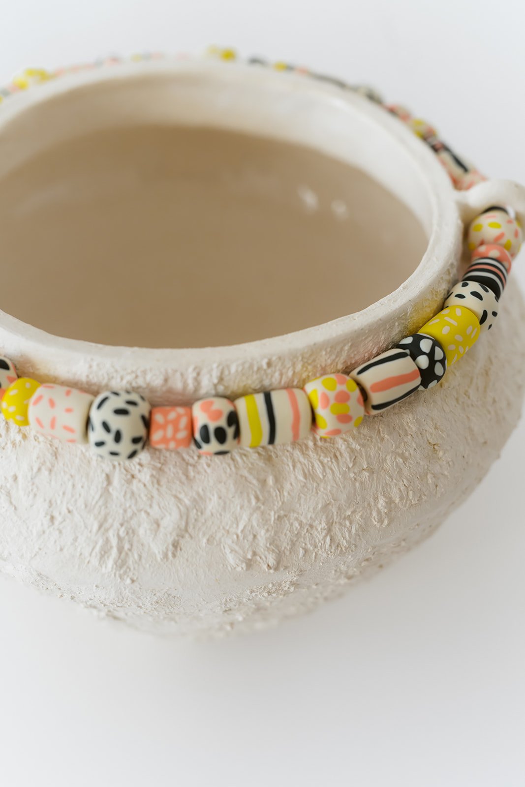 Fusion handmade white ceramic vase with grainy texture and colorful sculpted clay accents