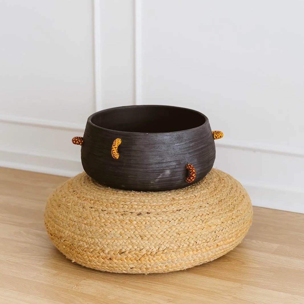 Echo handmade black pottery decorative bowl featuring intricate hand-woven fiber detailing and organic texture