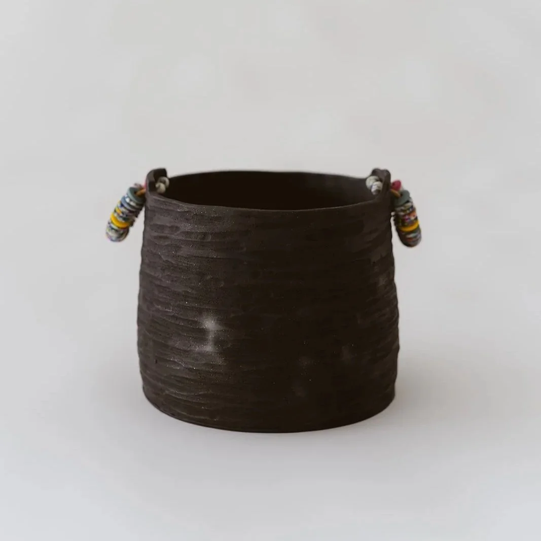 Noir handmade black pottery vase with textured finish and vibrant colorful rings