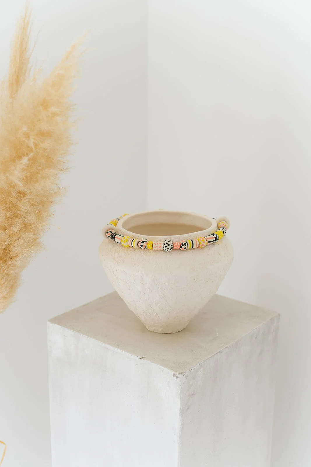 Fusion handmade white ceramic vase with grainy texture and colorful sculpted clay accents