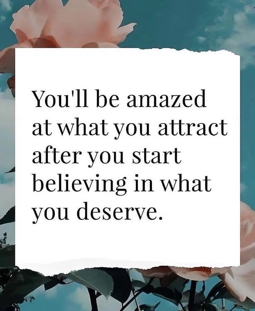 An inspirational quote overlay on a background with pink flowers and blue sky. The quote reads: "You'll be amazed at what you attract after you start believing in what you deserve."