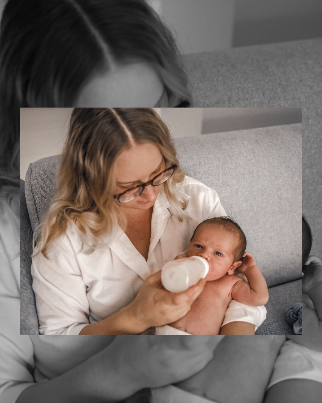 A woman with glasses is feeding a baby with a bottle while sitting on a couch.