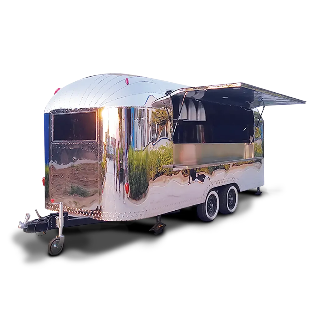 A shiny, silver food trailer with a black open serving window and dual wheels.