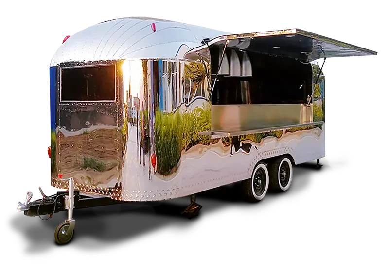 A shiny, metallic food truck with a large side window and an open serving counter, parked outdoors.