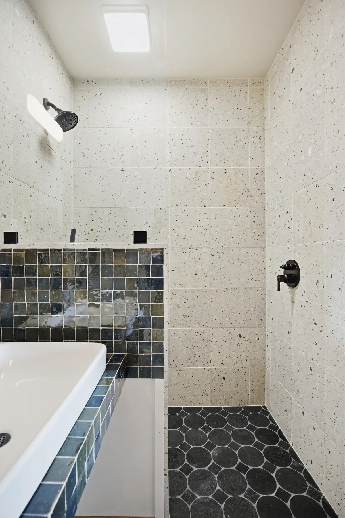 hey-house-room-1-bathroom-terrazzo-shower-mosaic-floor-1200w.webp