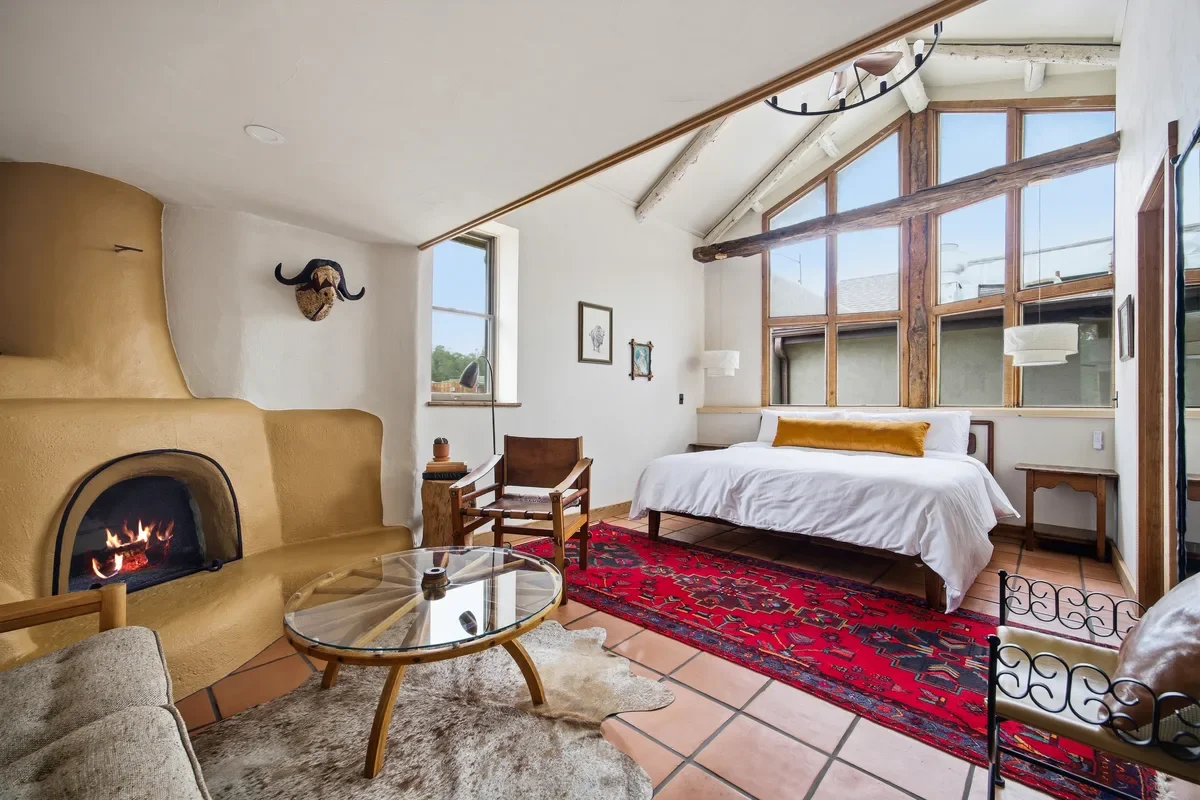 hey-house-room-4-bedroom-ochre-kiva-fireplace-large-windows-1200w.webp