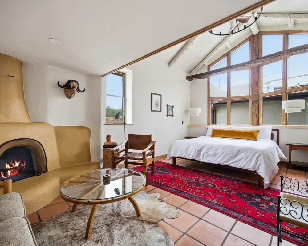 hey-house-room-4-bedroom-ochre-kiva-fireplace-large-windows-1200w.webp