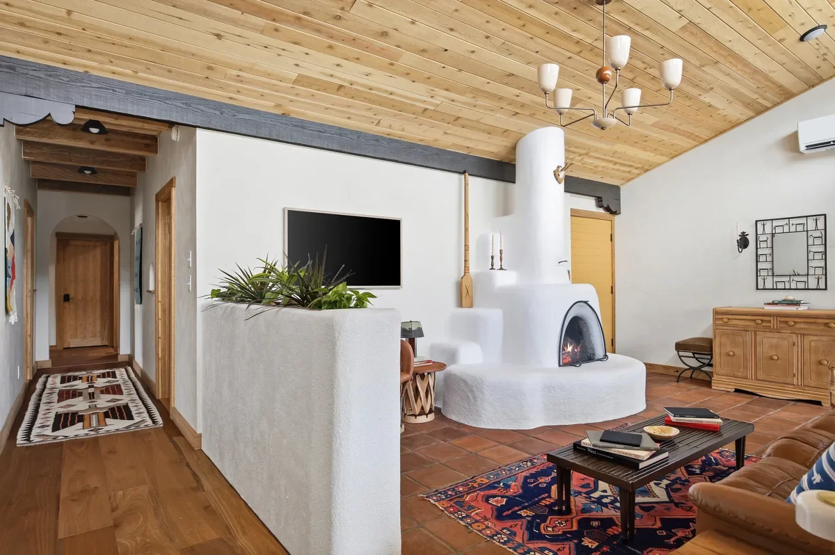 hey-house-living-room-kiva-fireplace-hallway-view-1200w.webp