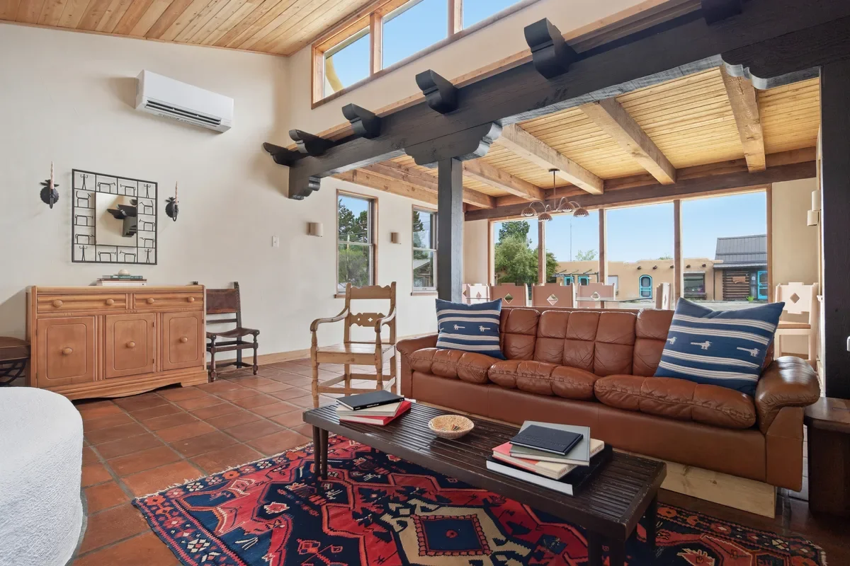 hey-house-living-room-leather-sofa-large-windows-1200w.webp