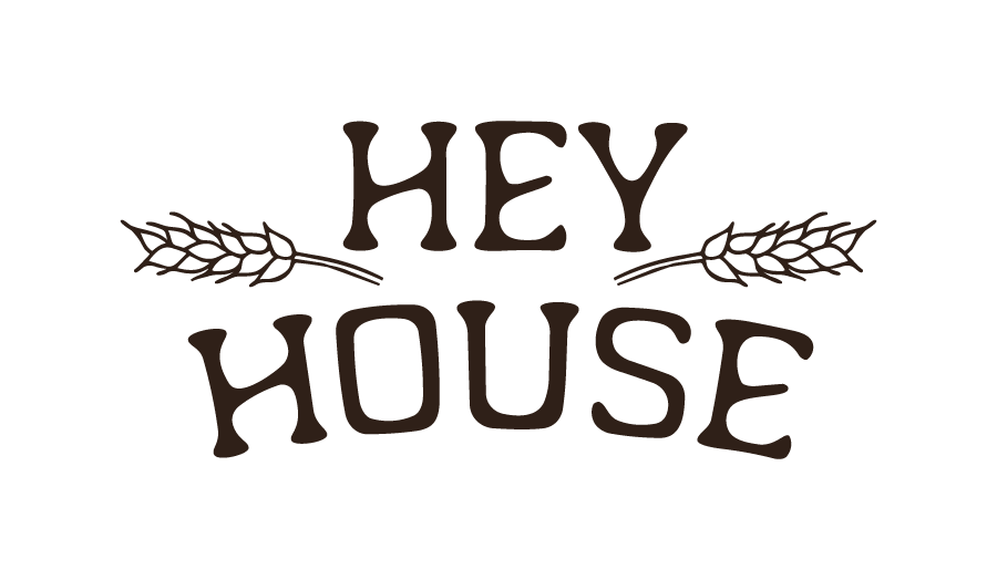 Text reading "HEY HOUSE" with decorative wheat stalks on either side.