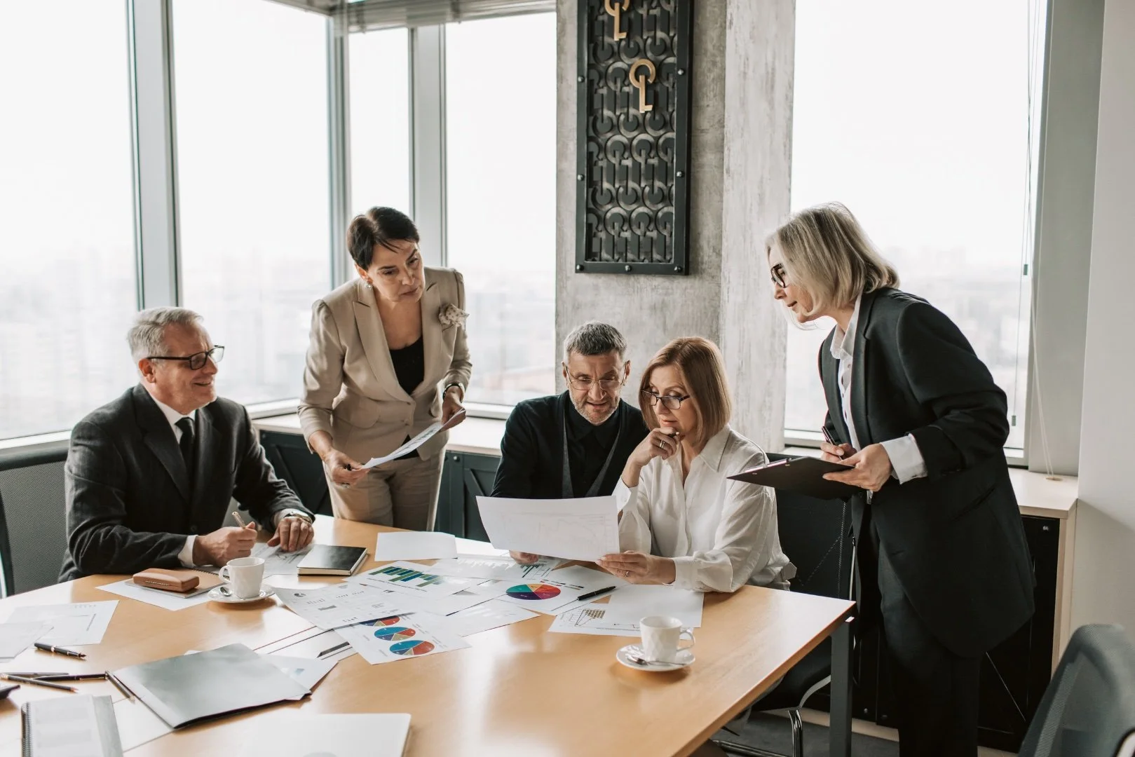 Team discussing a financial report together in their company's office.