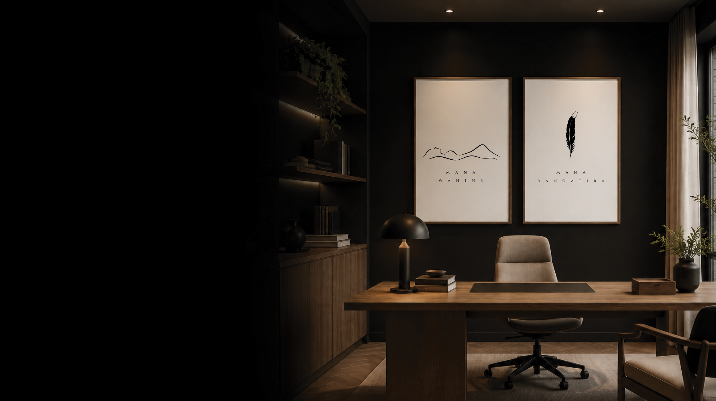 A modern, minimalist office with two framed art prints on a dark wall, featuring outline drawings of mountains and a feather, labeled 'Mana Wahine' and 'Mana Rangatira.' The office has a wooden desk, an ergonomic office chair, a table lamp, potted plants, and shelves with books, with natural light coming from a large window with curtains.