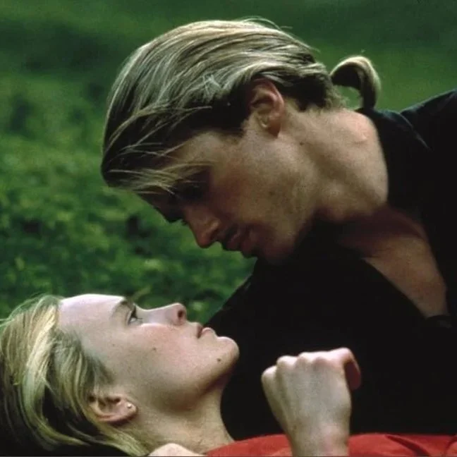 A film still from the family adventure film The Princess Bride (1987) featuring Cary Elwes and Robin Wright. A man and woman are embracing looking into each others eyes.