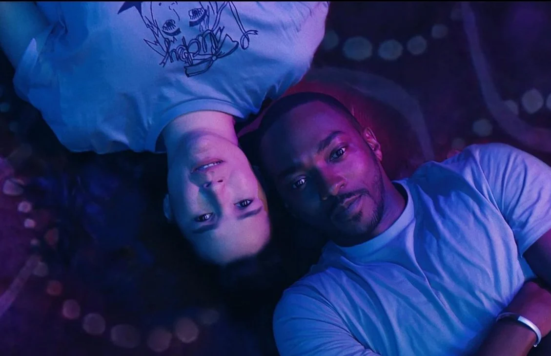 A film still from the rom-com film If You Were The Last (2023) featuring Zoe Chao and Anthony Mackie.  A woman and man lying next to each other looking up.
