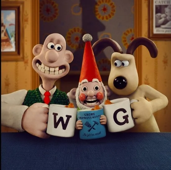Still from film Wallace and Gromit Vengeance Most Fowl (2024) three stop motion characters  are sitting at a table with a mug that has 'Gnome Improvement' written on it, and the other characters are holding lettered cups spelling 'W G'.