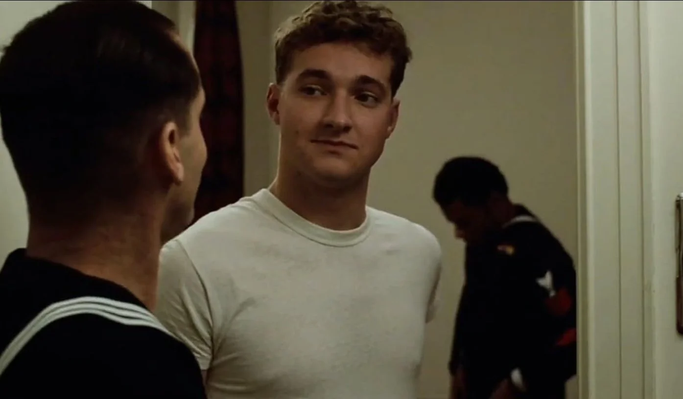 Two men having a conversation indoors, with one facing away from the camera and the other looking at him.  This is a still from the 1973 film The Last Detail directed by Hal Ashby, written by Robert Towne starring Jack Nicolson and Randy Quaid.