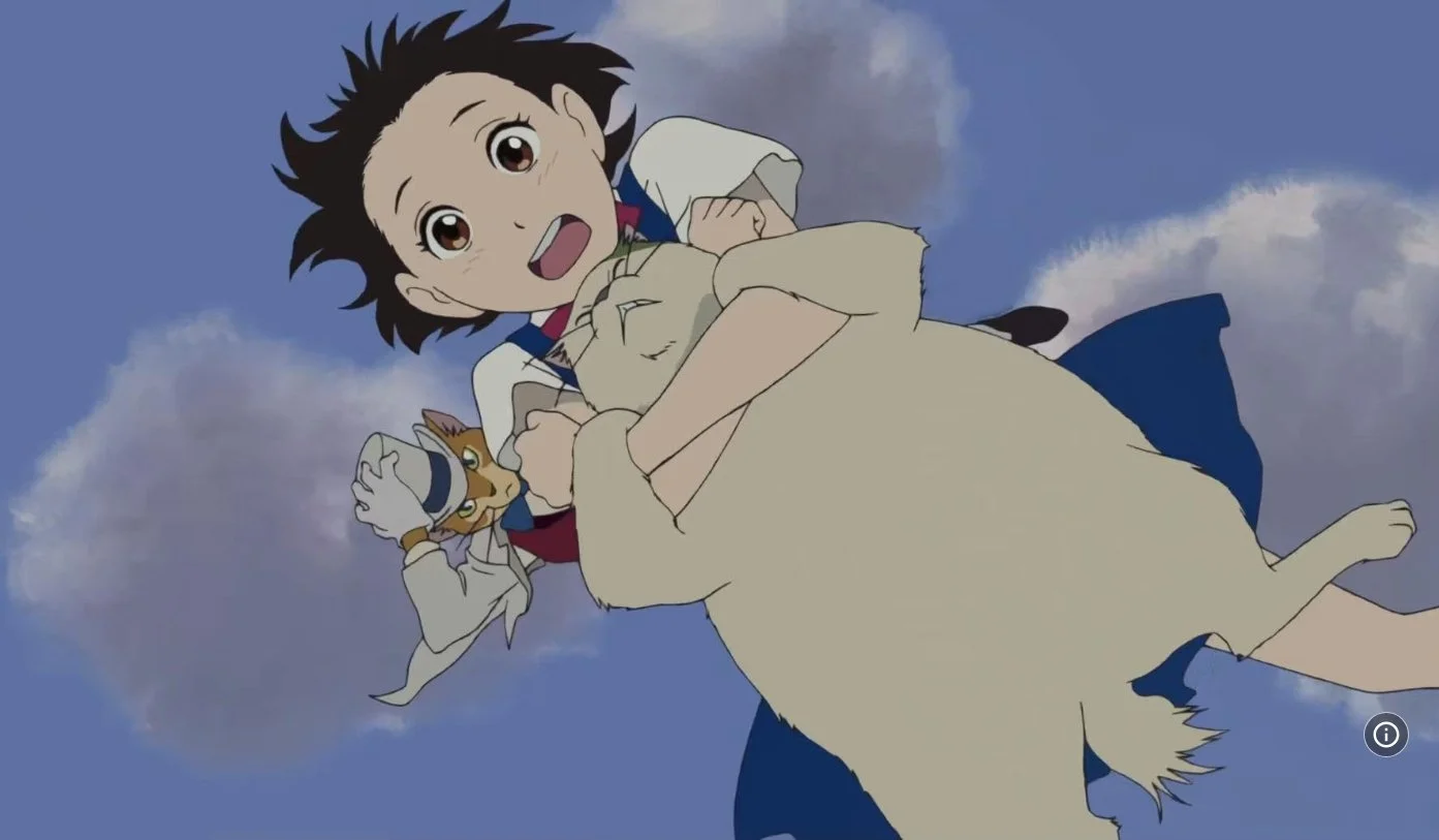 A film still from the animated Studio Ghibli film The Cat Returns (2002) featuring Anne Hathaway, Cary Elwes and Peter Boyle. A Girl holding a fat cat and another cat is behind her wearing a white suit and top hat.