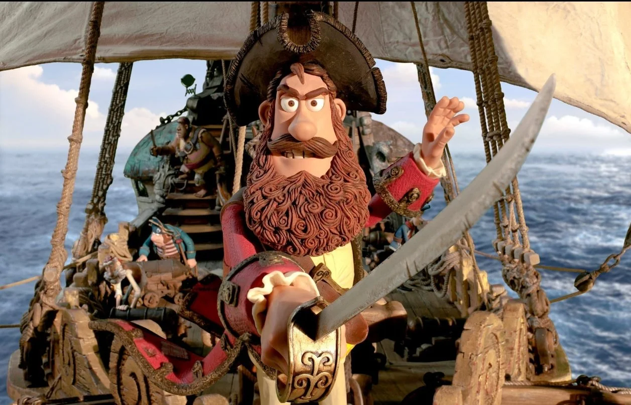 A still from the film The Pirates! an Adventure with Scientists! (2012). A stop motion animated pirate captain played by Hugh Grant holds a cutlass facing forward.