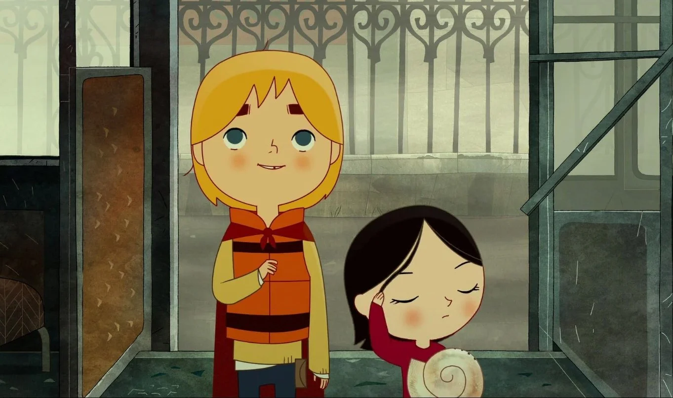 A still from Song of the Sea (2014). A brother with blonde hair and a sister with black hair stand next to each other, the boy wears a cape and life jacket, the girl is holding a large seashell.
