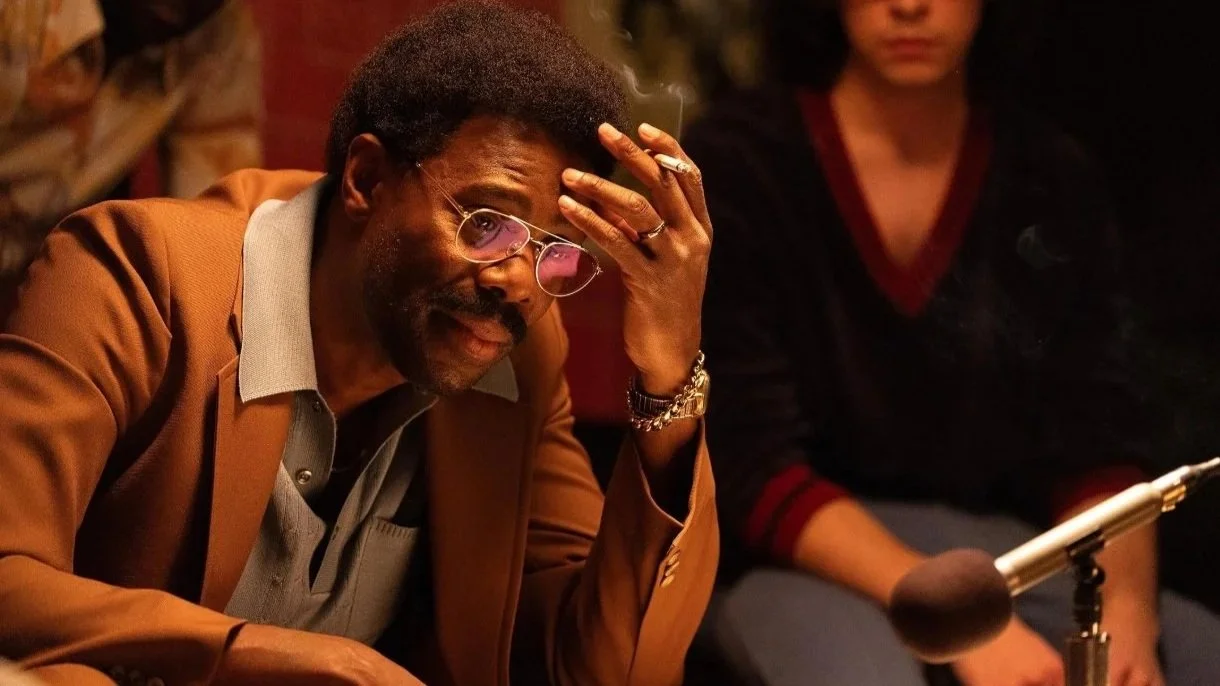 a film still on Colman Domingo looking at a microphone, smoking and wearing sunglasses, from the 2025 film Dead Man's Wire.
