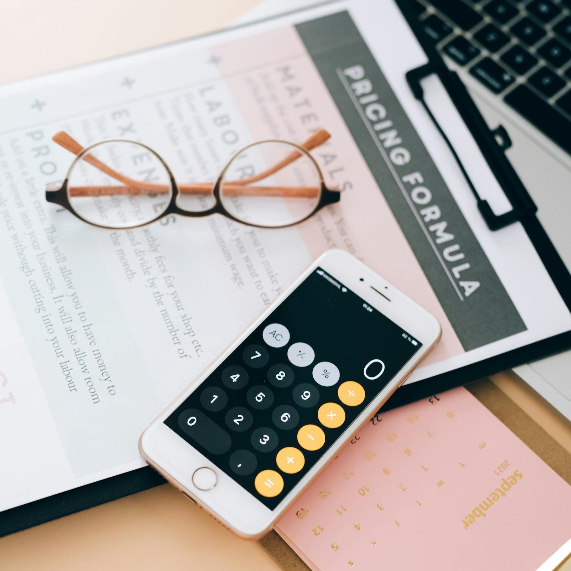 Calculator, glasses, calendar and fee schedule representing transparent gynaecology consultation pricing and payment options