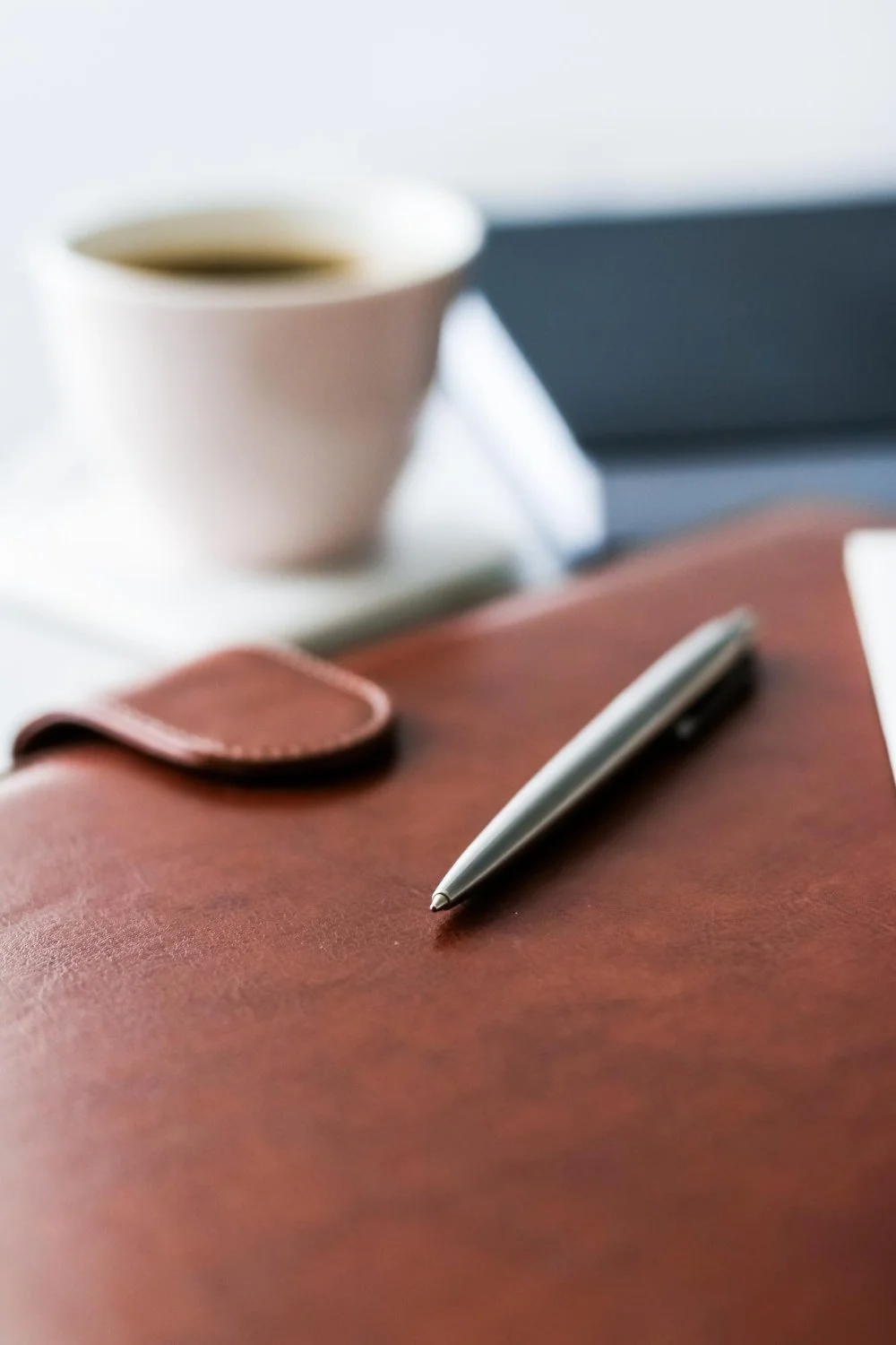 Clipboard, pen and coffee cup on a desk representing professional medical legal reporting and expert witness services