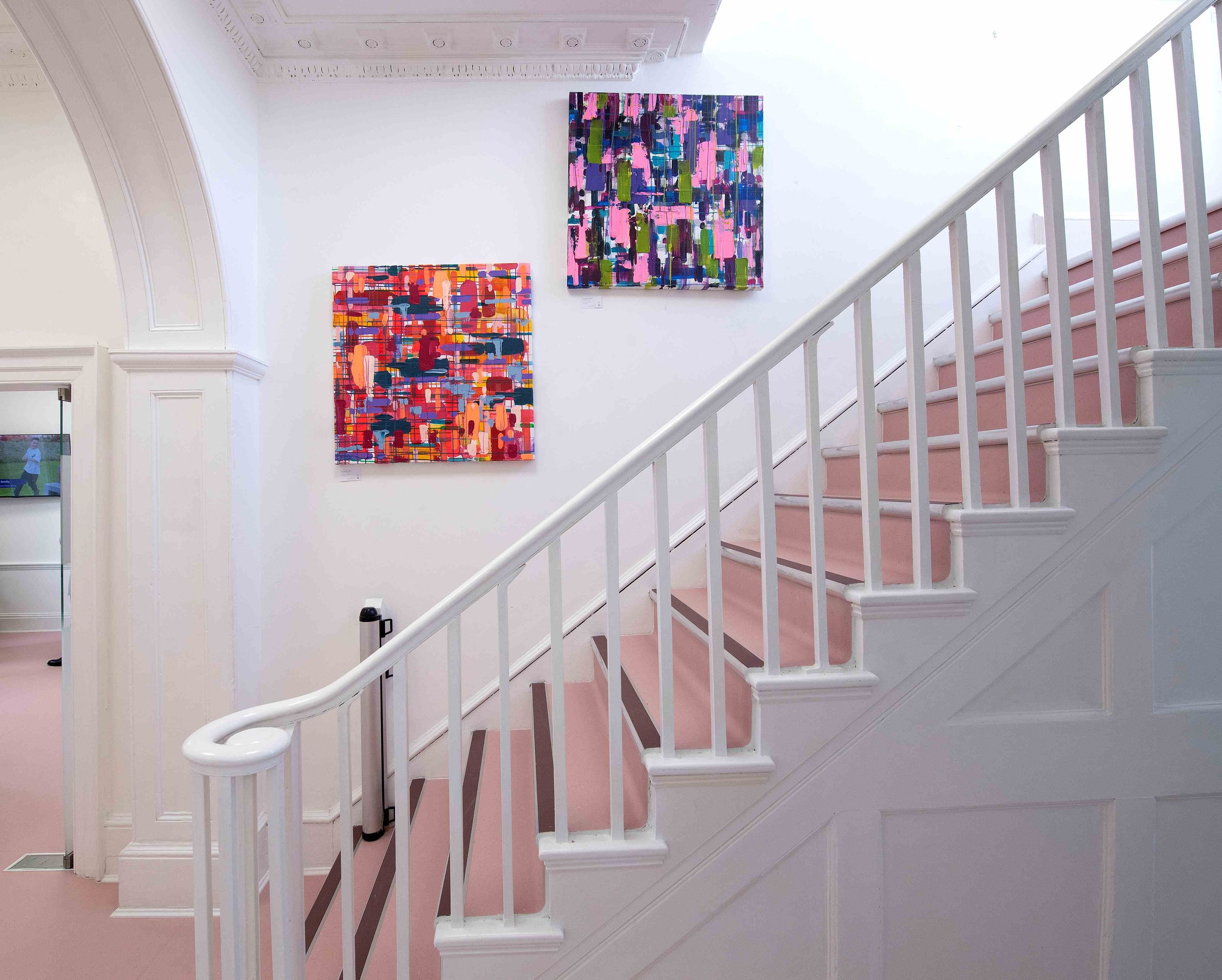 Interior staircase and wall art at Chase Lodge Hospital, showcasing the hospital's comfortable and modern environment