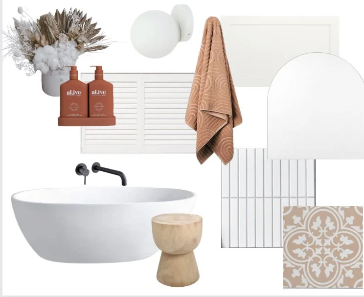 Interior bathroom design featuring a white oval bathtub, a black faucet, a small wooden stool, a peach-colored towel hanging on a hook, a white wall sconce, along with decorative items like a vase with dried flowers, two orange bottles, and patterned