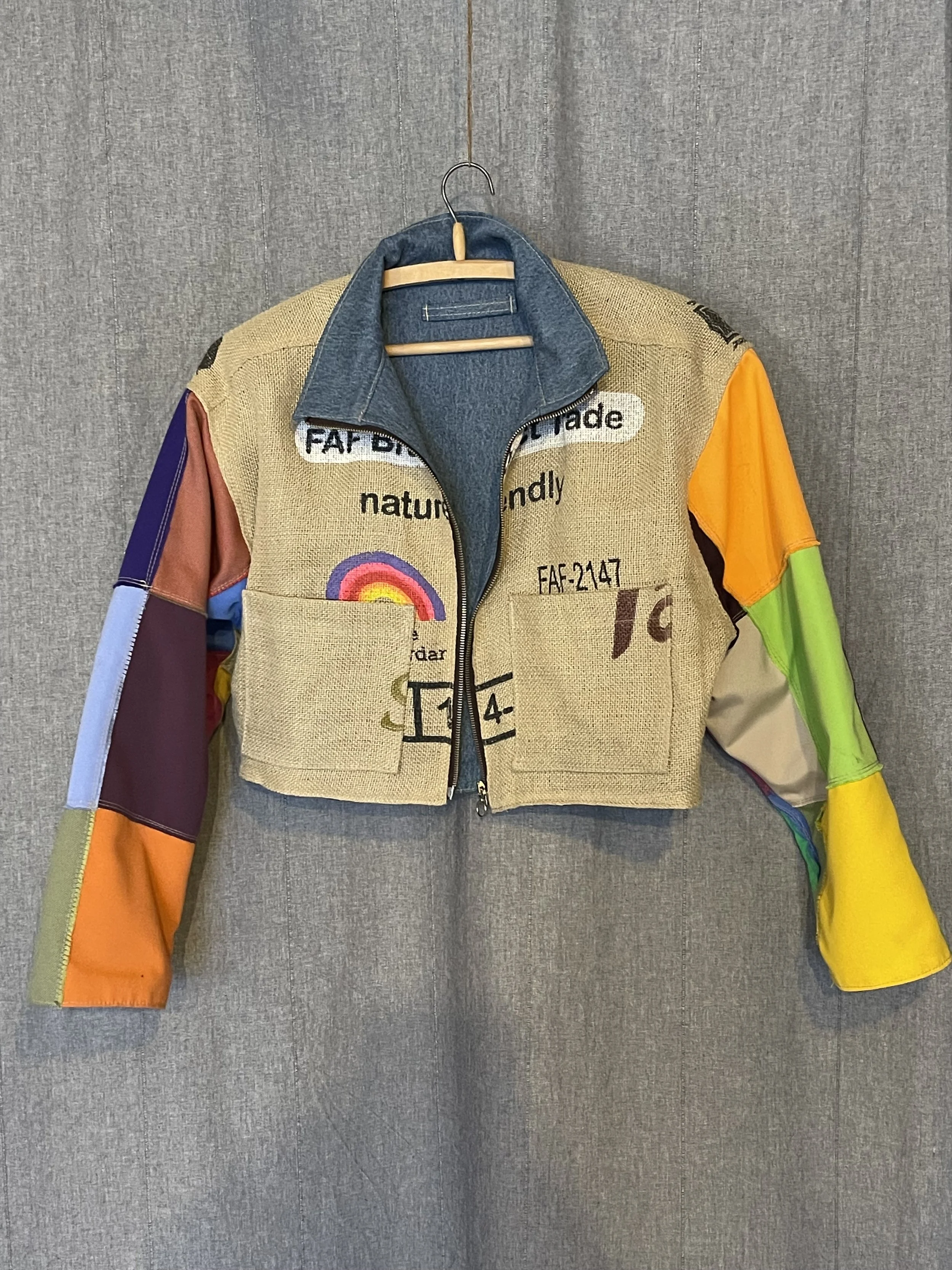 Colorful jacket with patchwork sleeves hanging on a wall