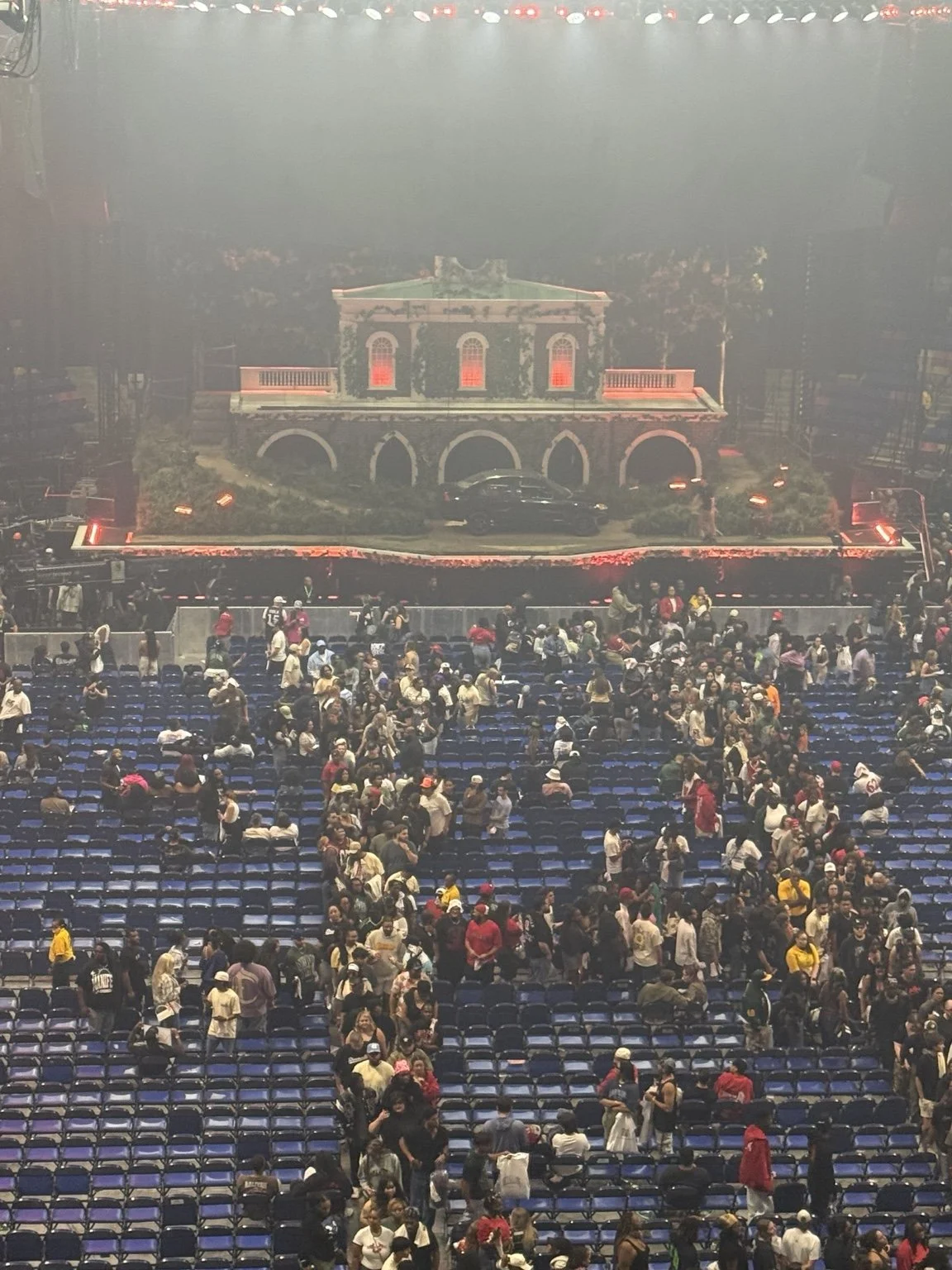 A Market House set onstage during J. Cole’s The Fall-Off tour, viewed from the audience.