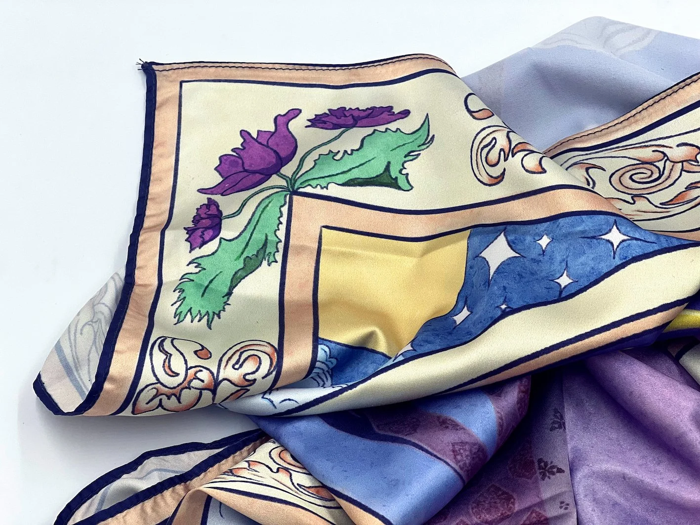 Silk scarf printed with the illustration, extending the artwork into a wearable format.