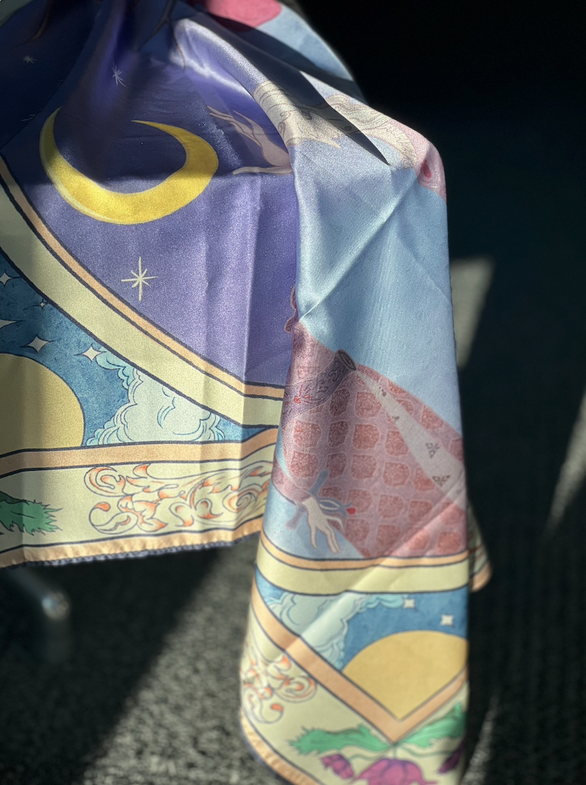 Silk scarf printed with the illustration, extending the artwork into a wearable format.