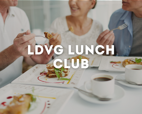 People enjoying lunch at a table with cakes and coffee, with the text 'LDVG Lunch Club' overlaid.