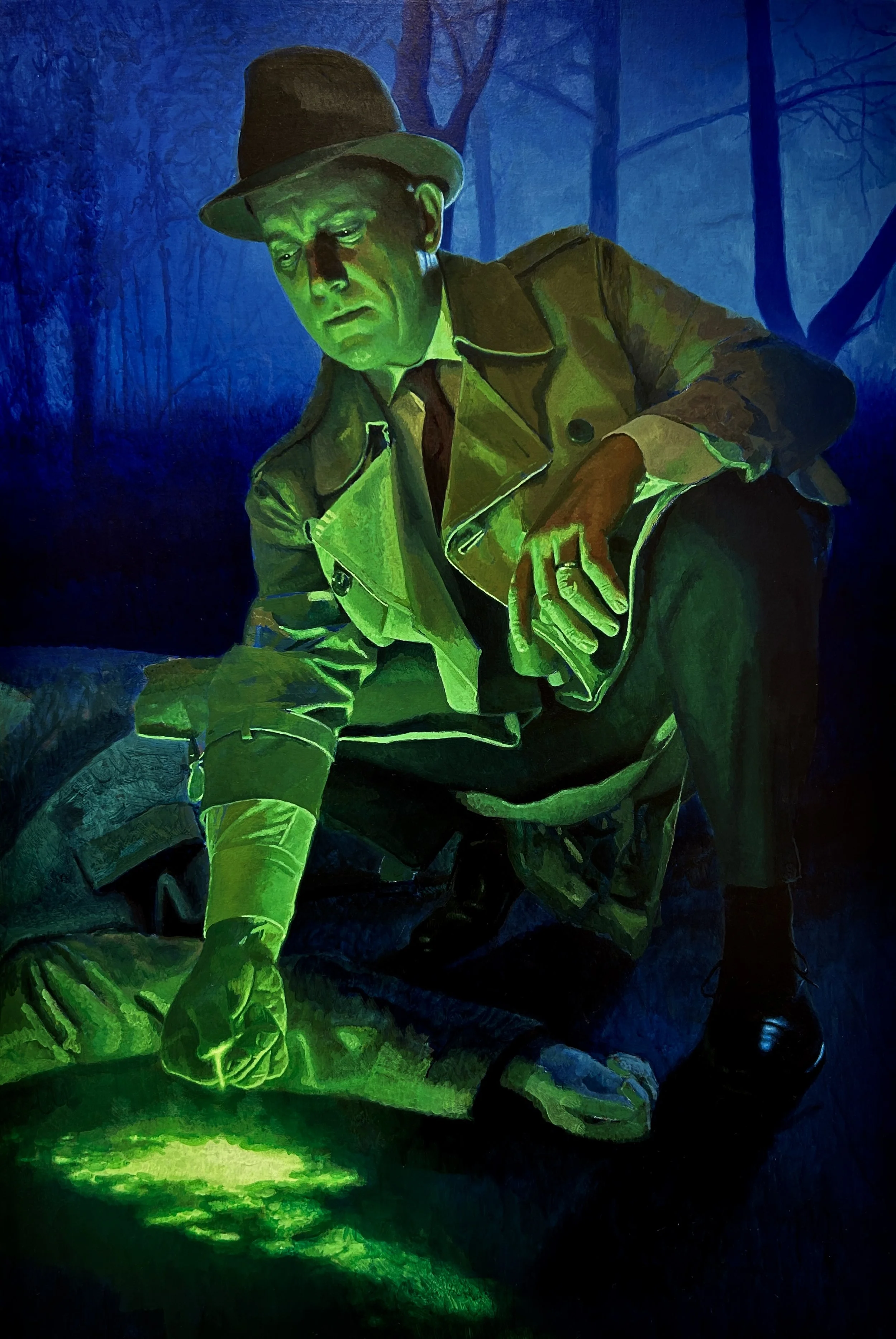 A man dressed as a detective in a trench coat and fedora hat, illuminated with green light, in front of a dark, eerie forest background at night.