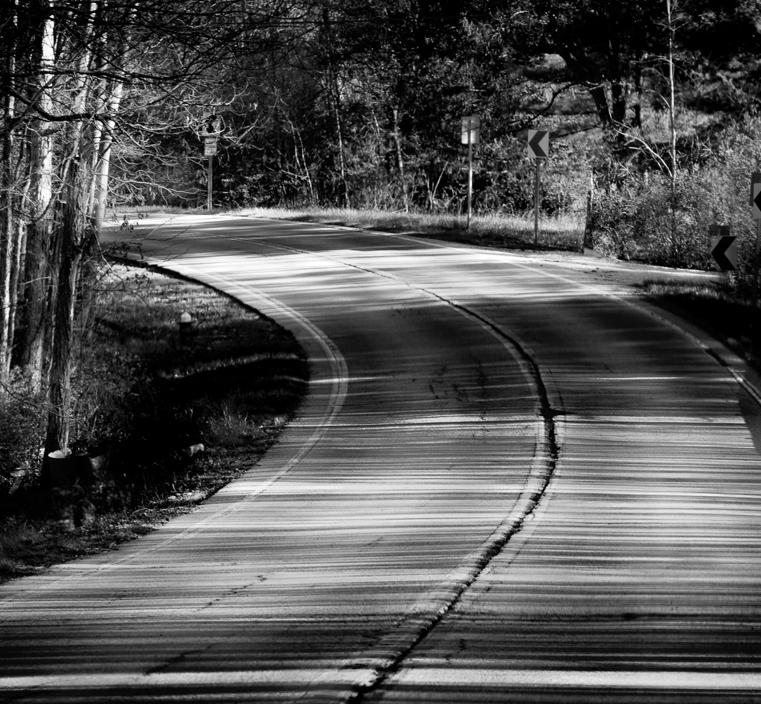 Soft light follows the road as it winds peacefully through the landscape.