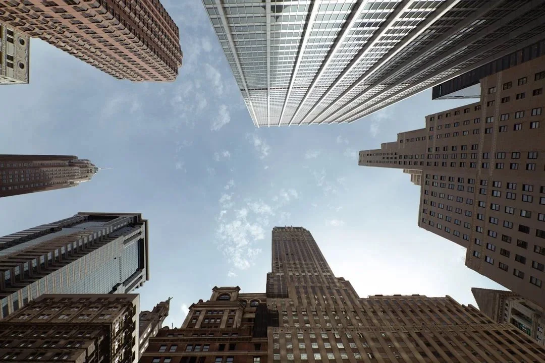 image looking up at blue sky and NYC sky scrapers