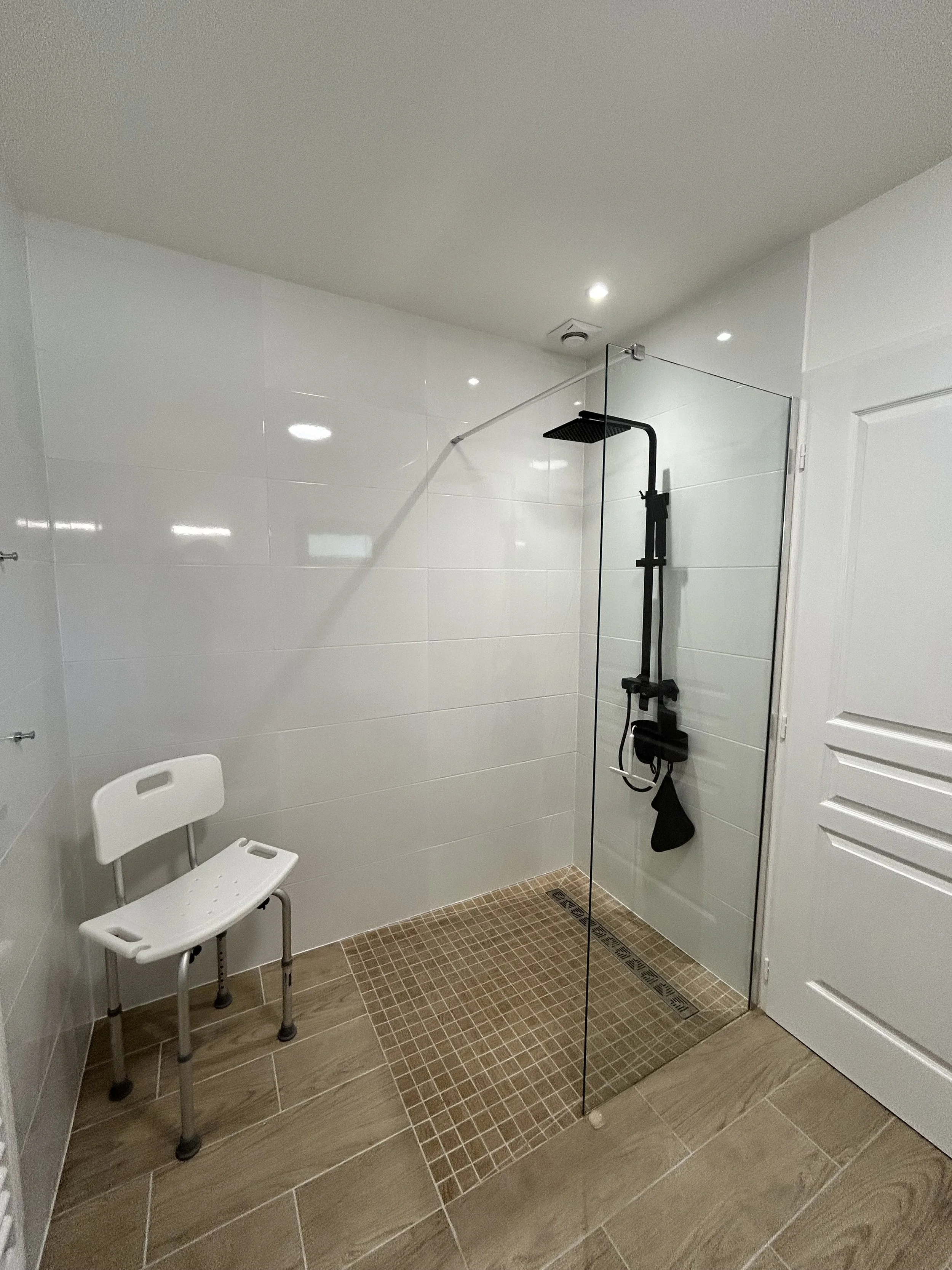 Downstairs shower room showing shower and seat.jpeg