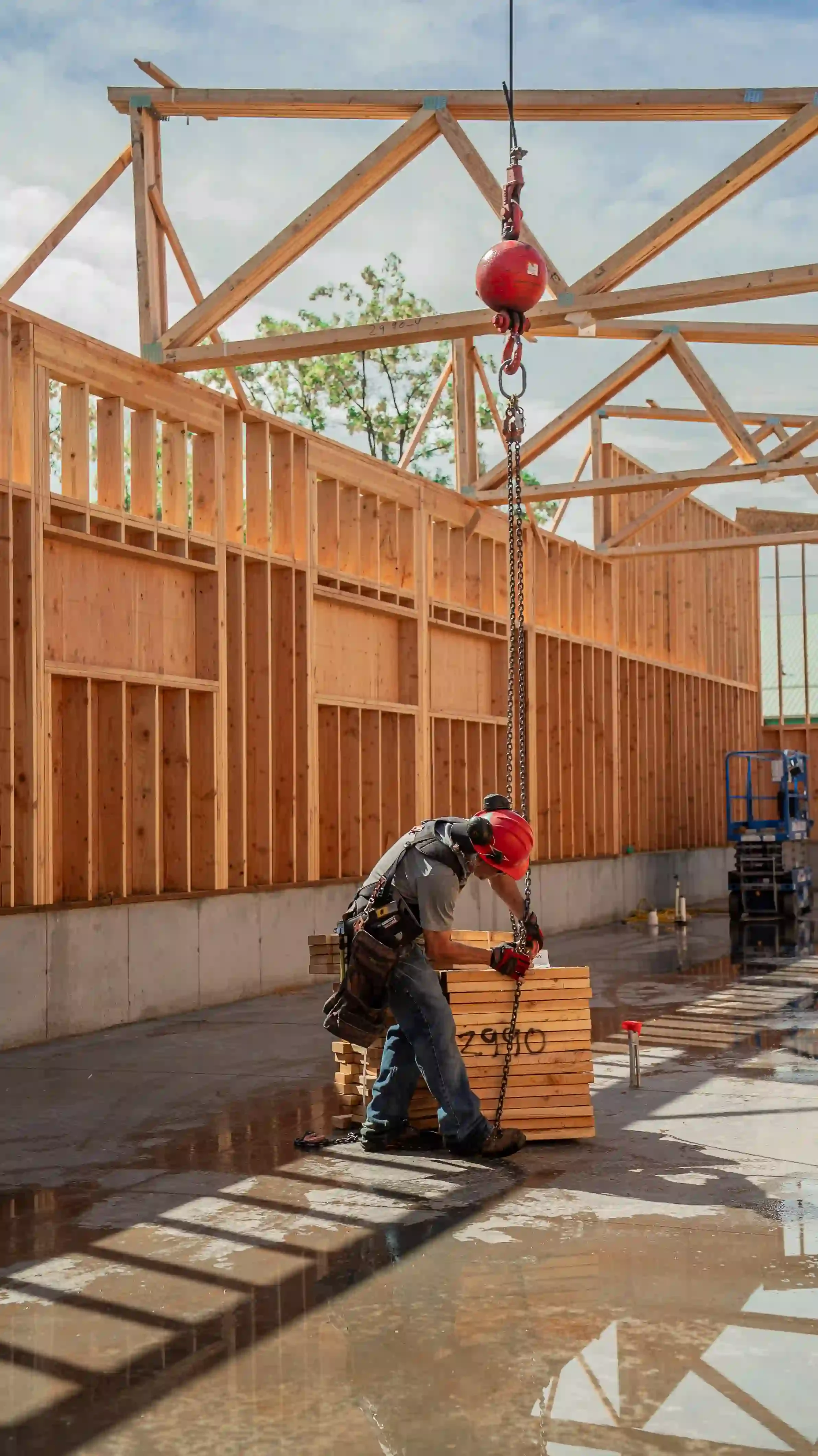 Jepsen Construction worker preparing lumber for roof framing installation